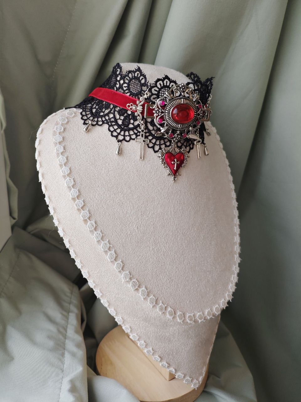 Side view of handmade red gothic cross choker with black lace