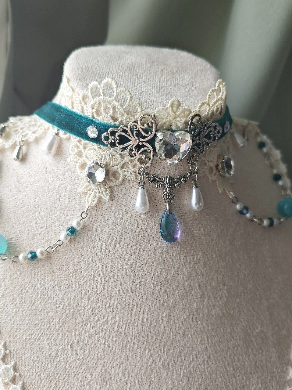 Close-up of Wings of the Silver Tide turquoise velvet and glass details